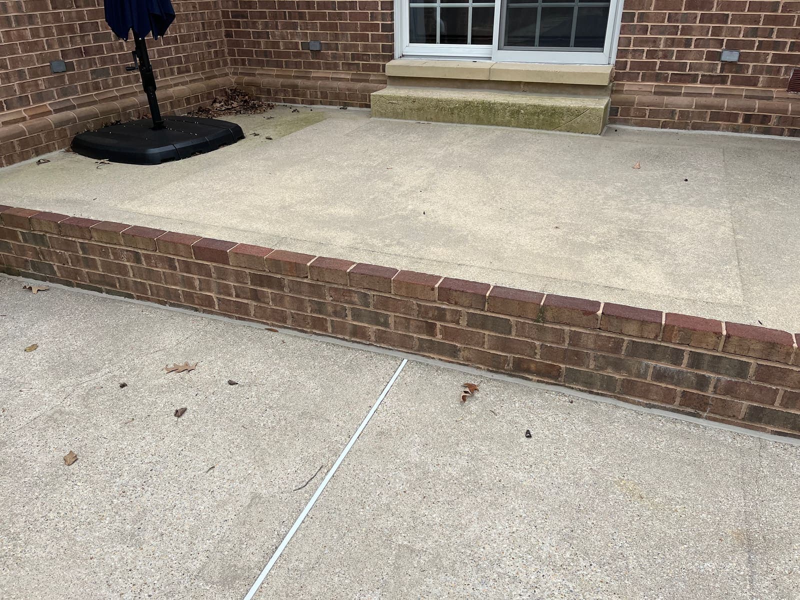 Brick-bordered concrete patio after cleaning