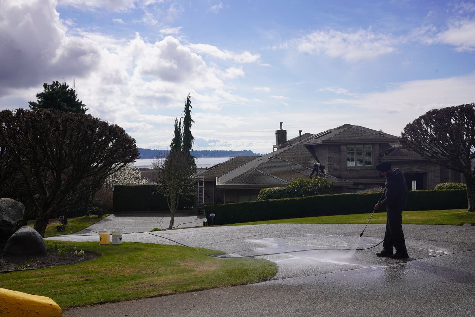 Wide clean driveway after pressure washing at a hillside estate