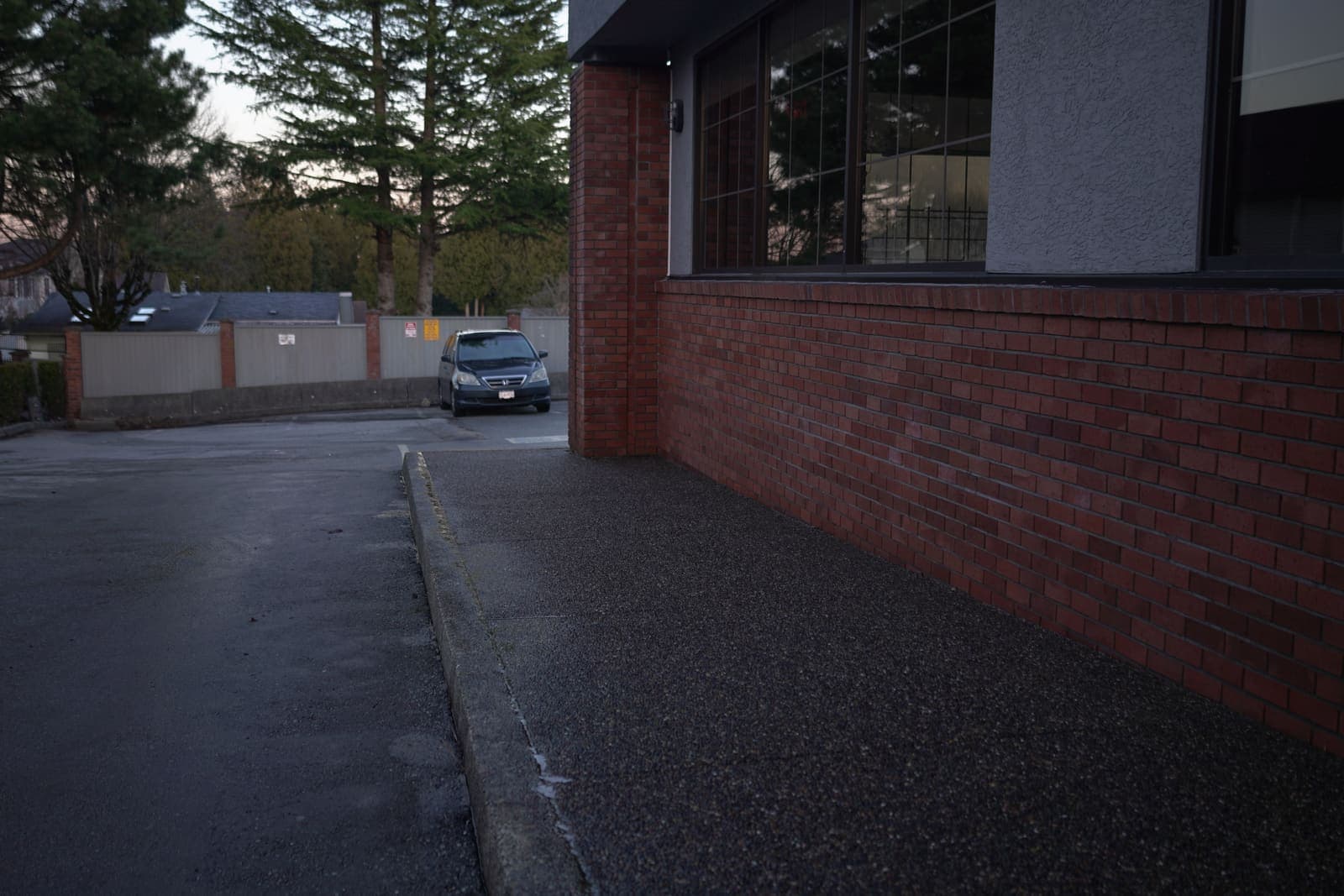 Commercial parking lot and building edge after pressure washing
