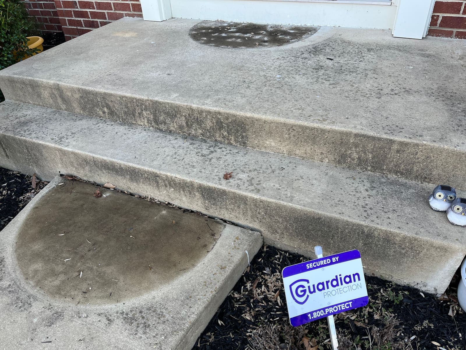 Stained concrete front step before pressure washing