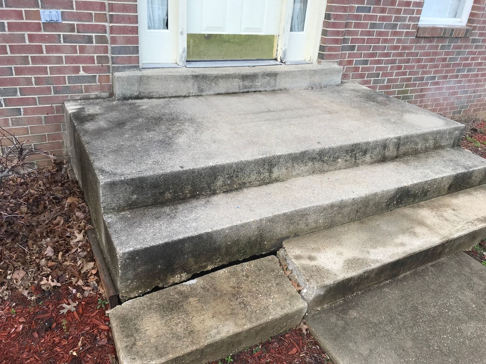 Stained concrete front steps before pressure washing