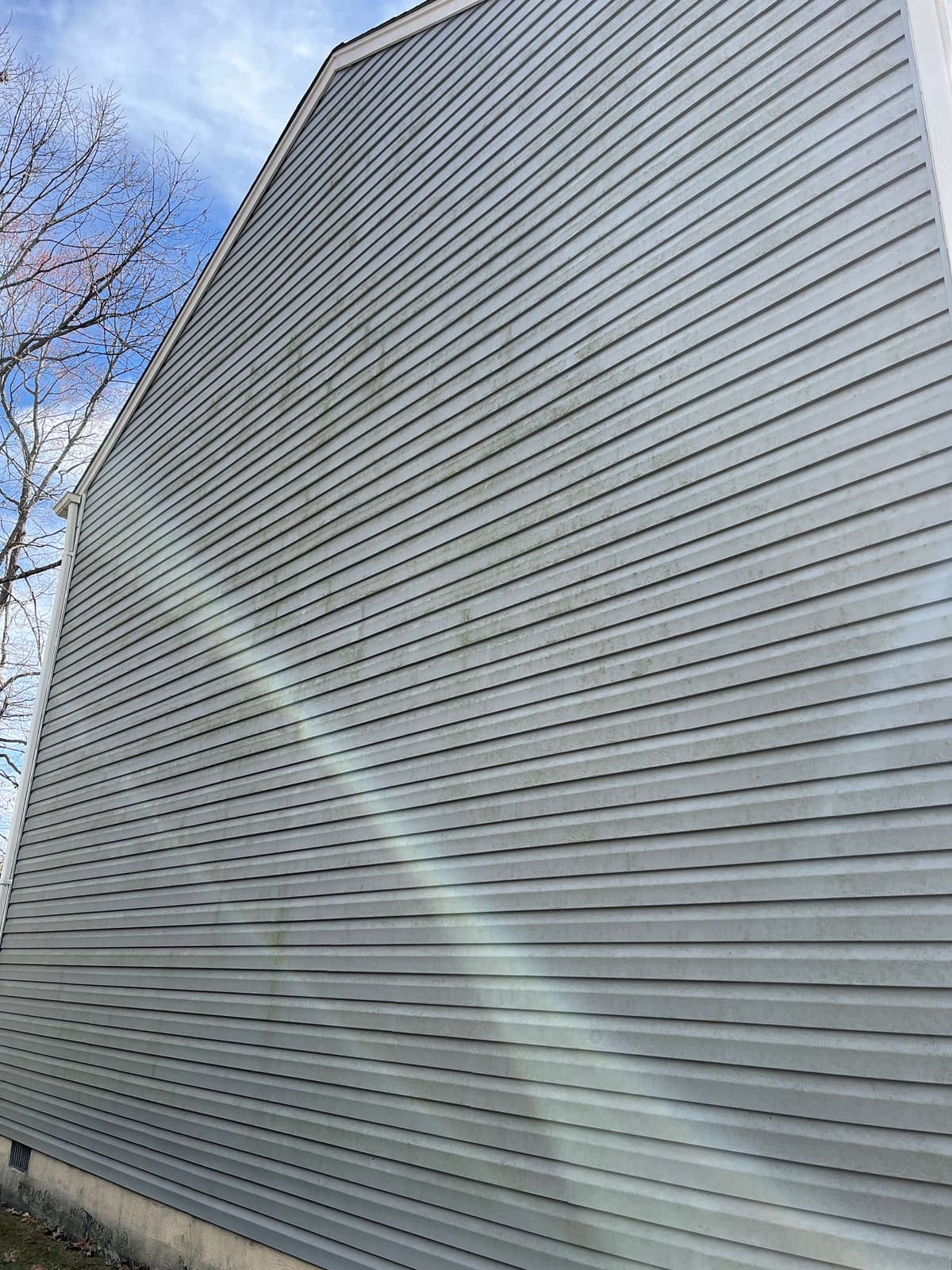 Grey siding panel clean after soft washing