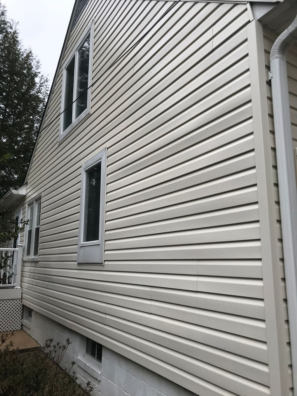 Streaked house siding before a soft wash
