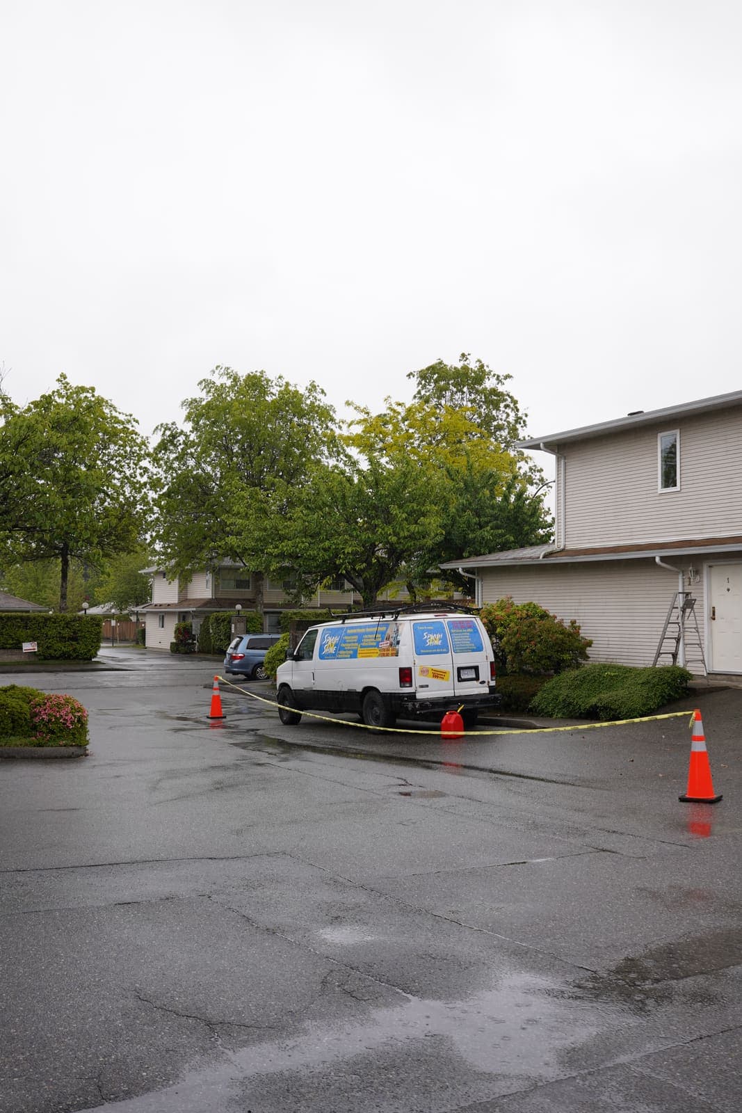 Service van parked in a strata complex during an exterior cleaning job
