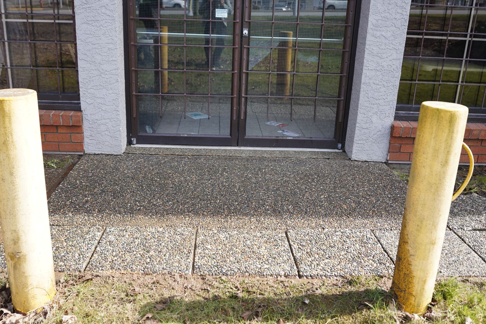 Storefront glass and entry walkway after professional window cleaning