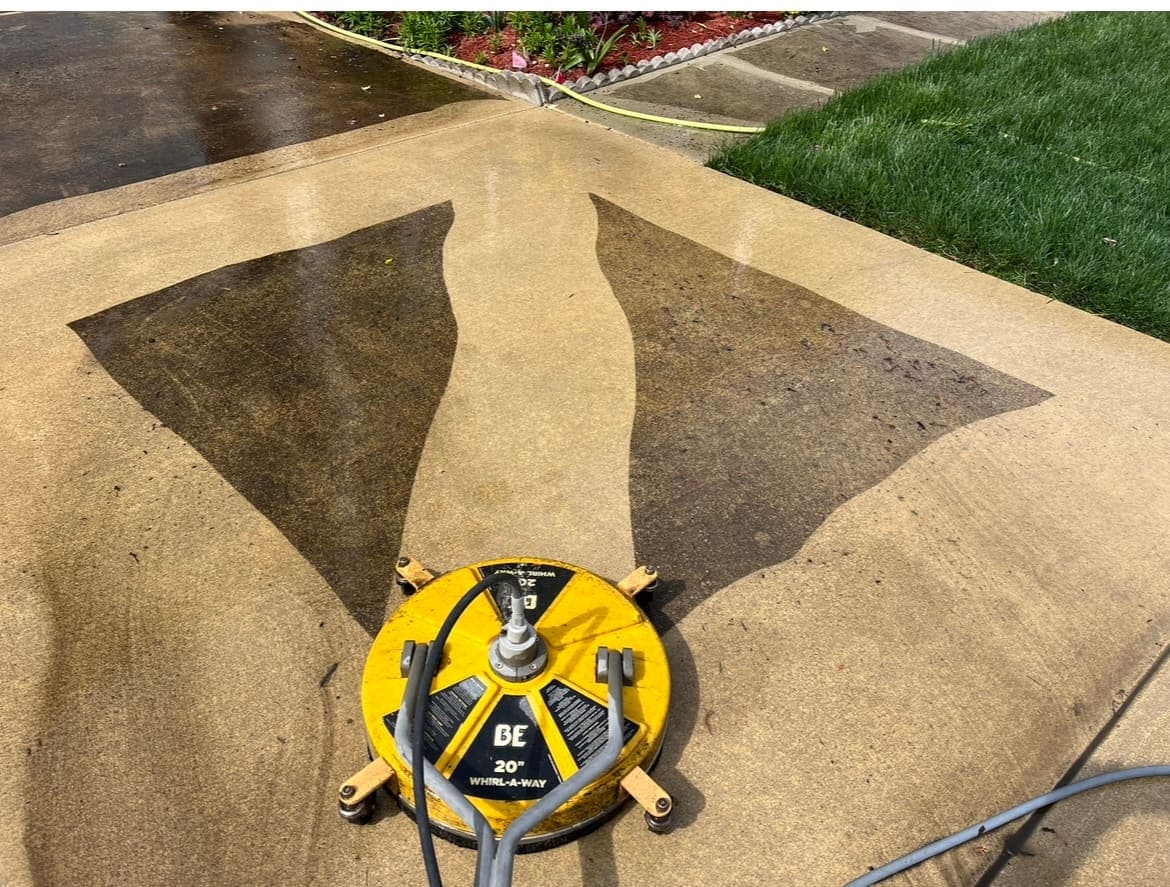 Surface cleaner leaving a sharp clean line across a concrete driveway