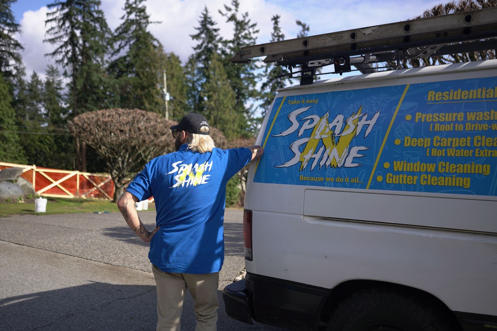 Technician at the rear of the service van setting up equipment