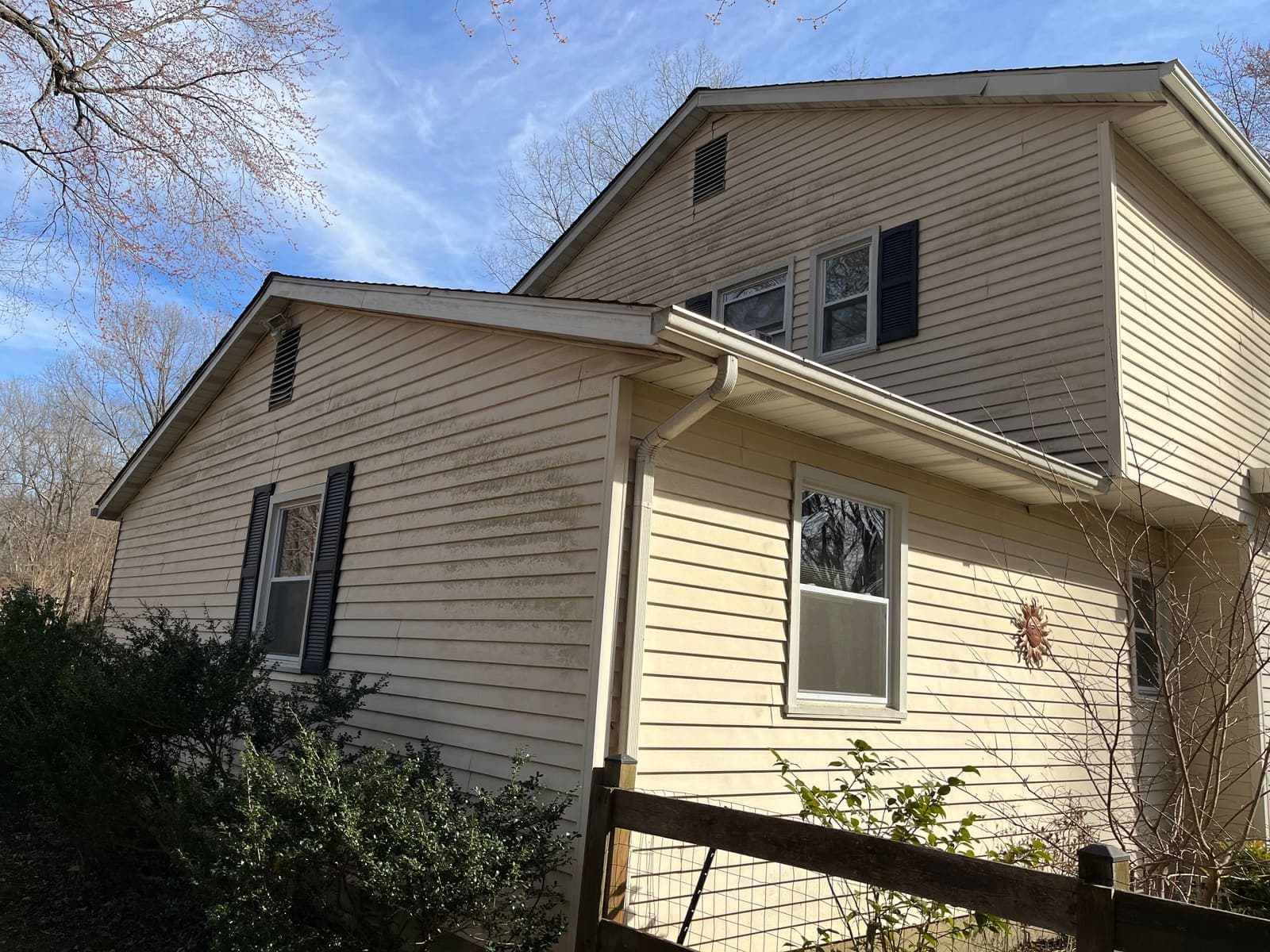 Yellow-sided house before a soft wash