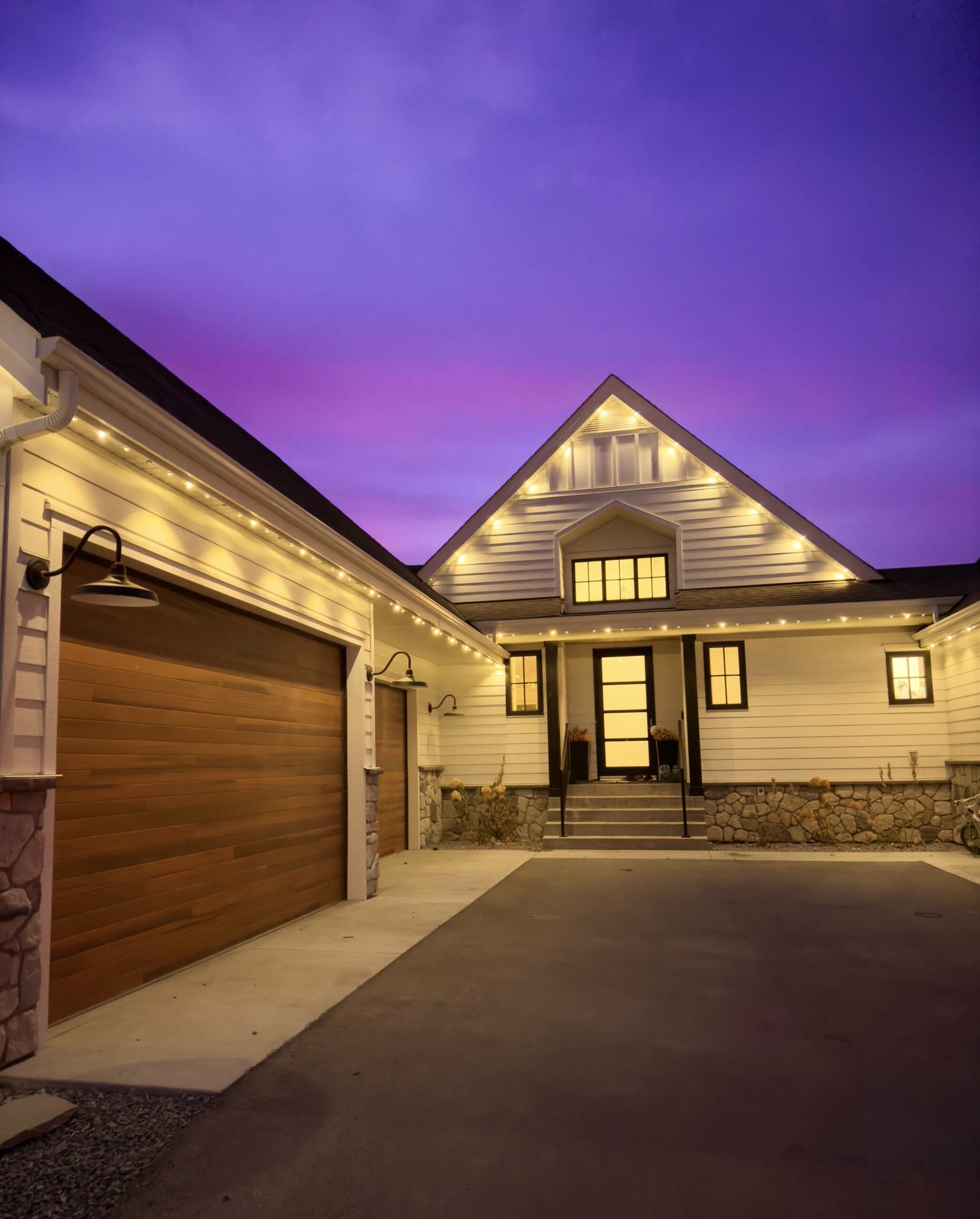 Permanent cool-white LED lights tracing the rooflines of a modern two-storey home at night — Permanent Holiday Lights in Langley, BC