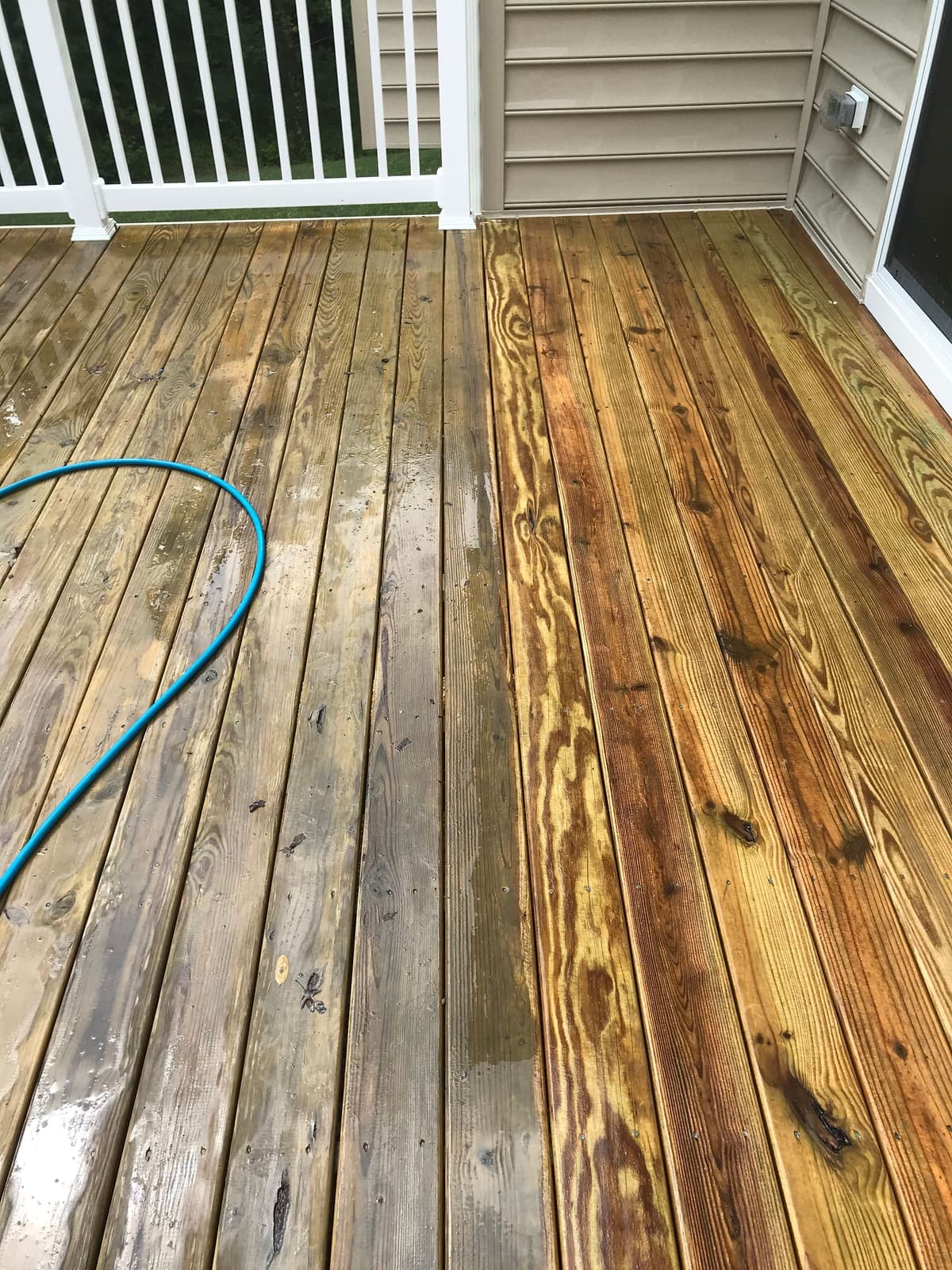 Wood deck boards being cleaned along the grain with a low-pressure fan tip