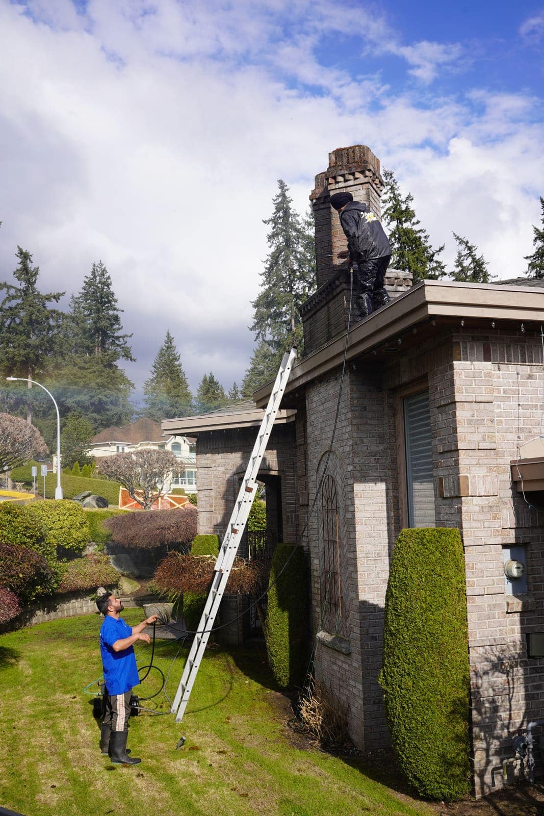 Extension ladder set against a stone house for safe roof access