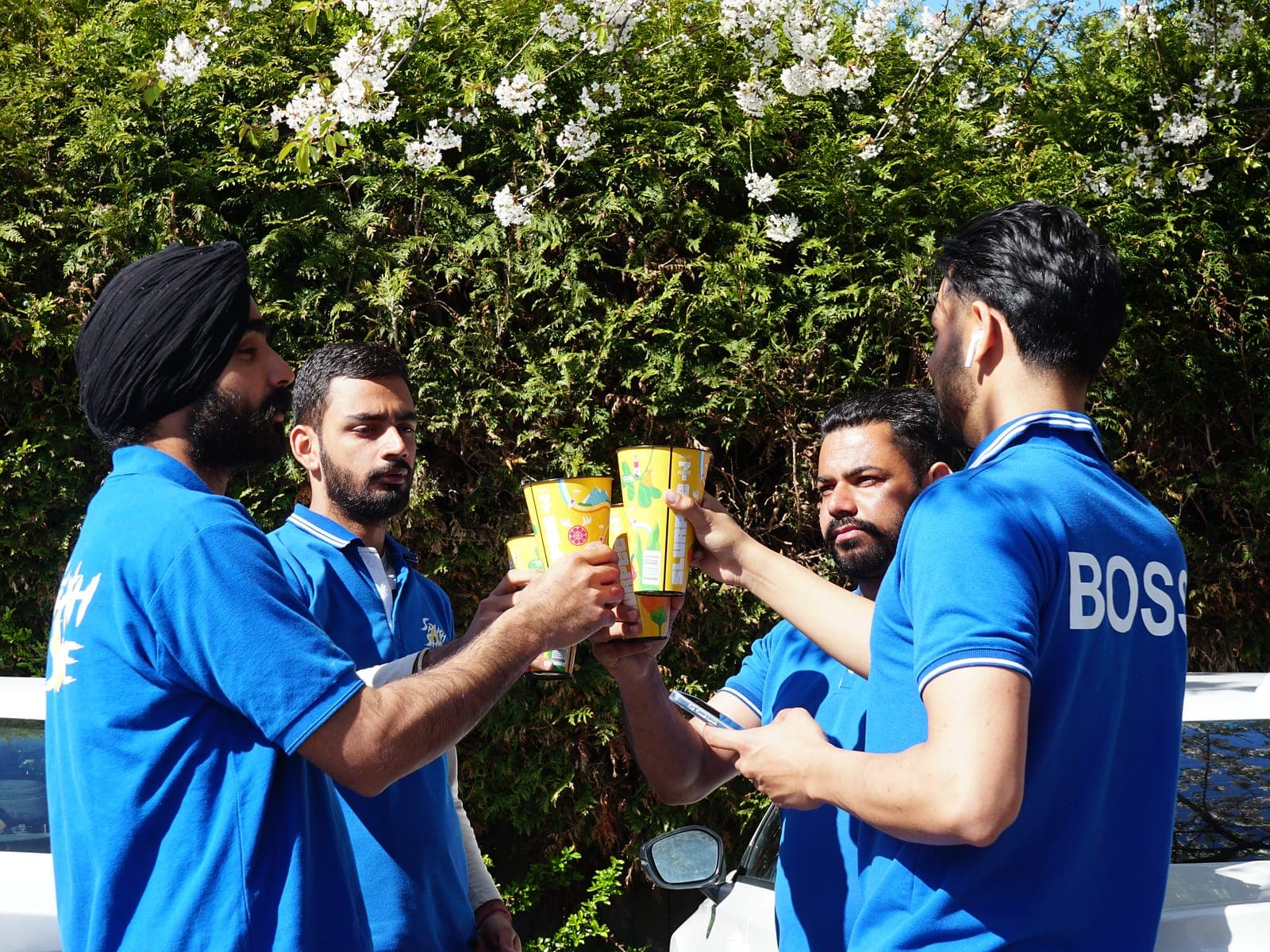 Splash N Shine technicians taking a break together between jobs on a sunny day