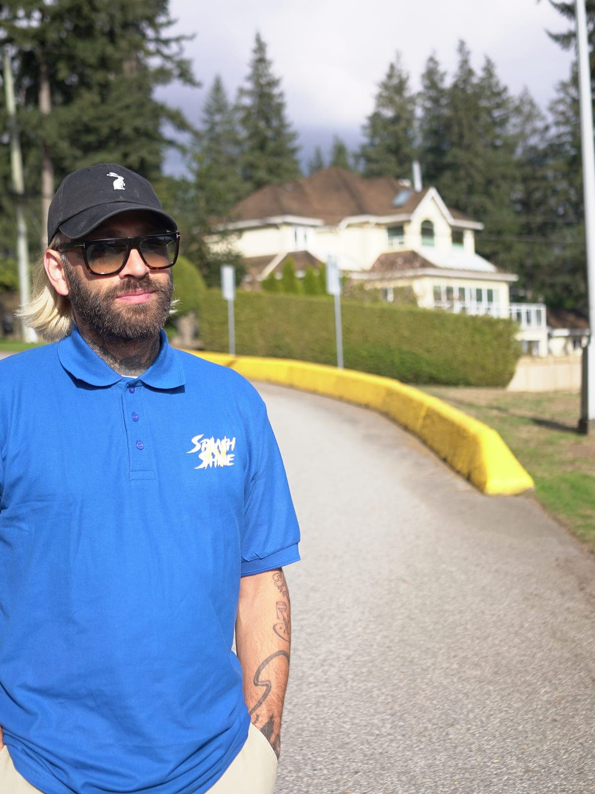 Uniformed Splash N Shine technician on a residential driveway in the Lower Mainland